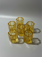 Matching amber crystal cordial glasses with substantial geometric faceted bases.