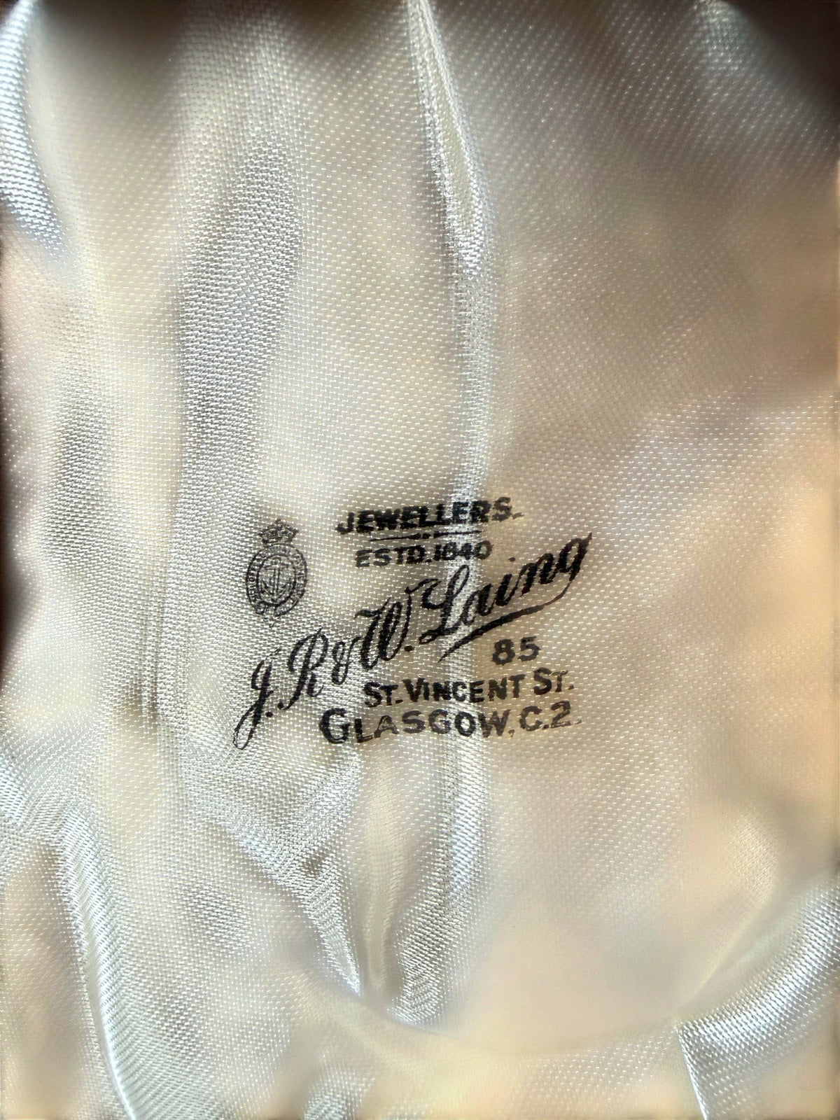 Silk lining of the presentation case showing the J. R. McIlwaine Glasgow retailer’s mark.