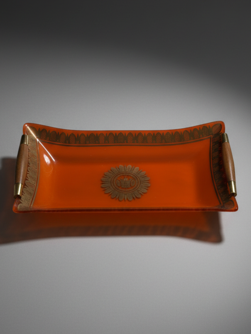 Detail of gilt decoration and central medallion on Georges Briard orange glass serving tray.