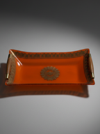 Detail of gilt decoration and central medallion on Georges Briard orange glass serving tray.