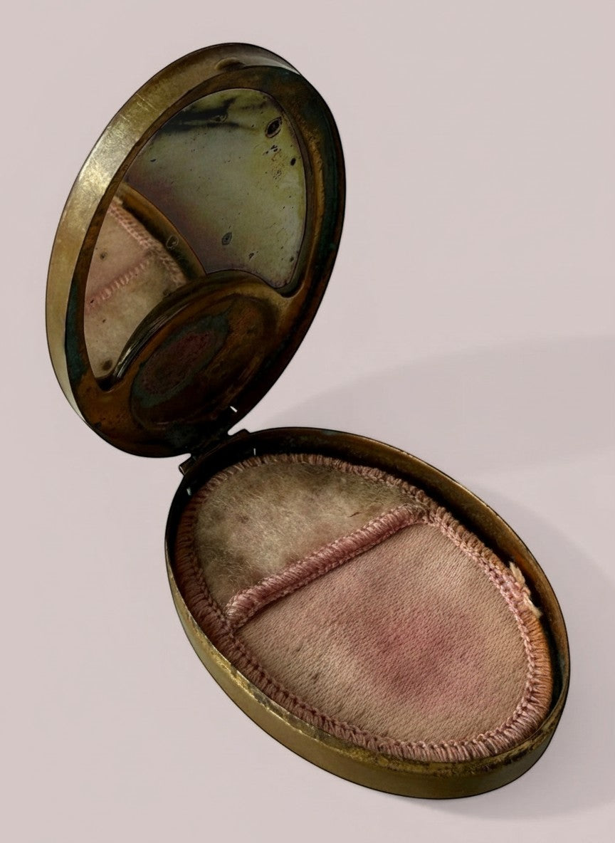 Atlas & Arden 1930s oval brass compact with original mirror and pink silk powder puff, featuring hand-painted British folk art.