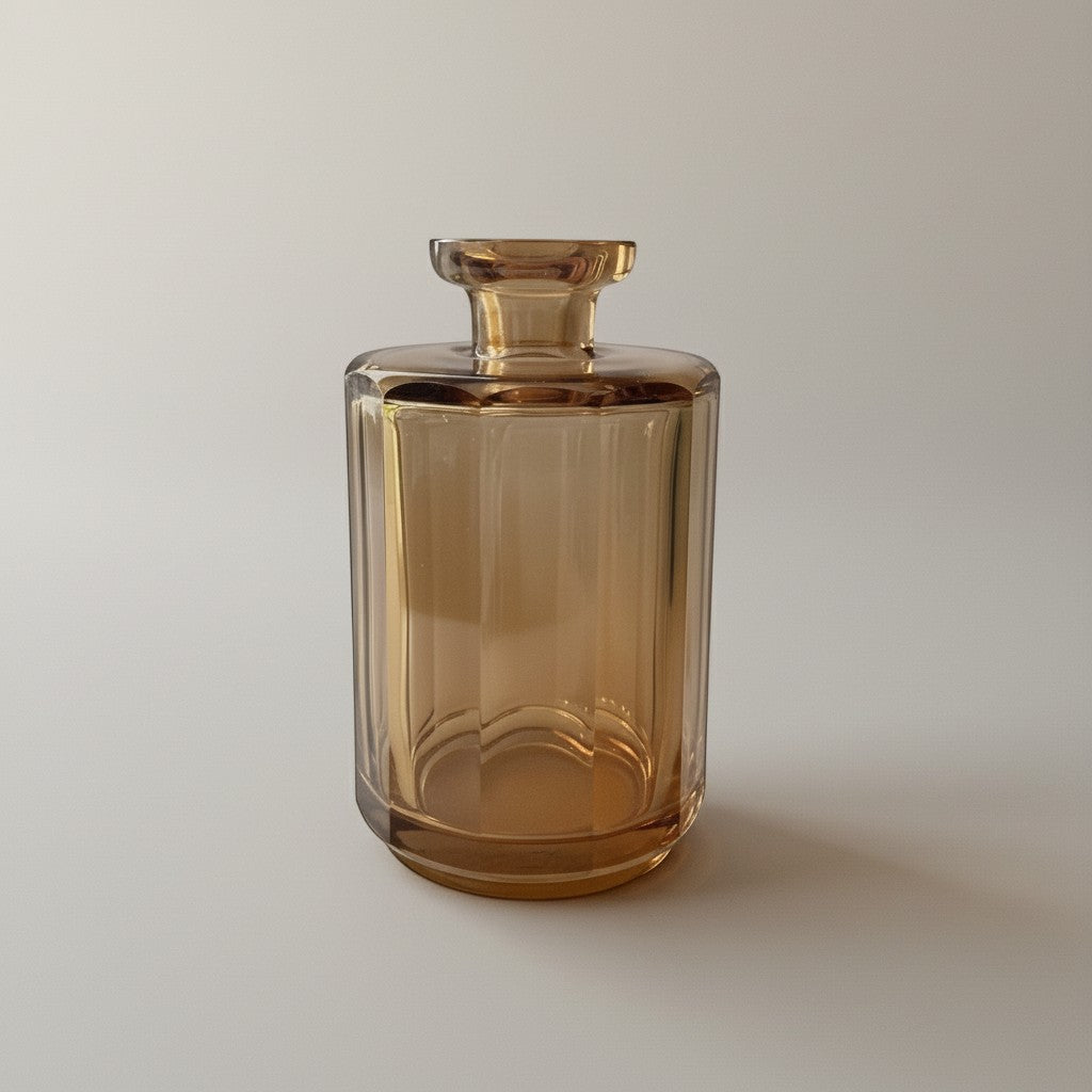 Atlas & Arden heavy cut amber glass vessel with paneled sides and faceted neck, 8.5 inches tall.
