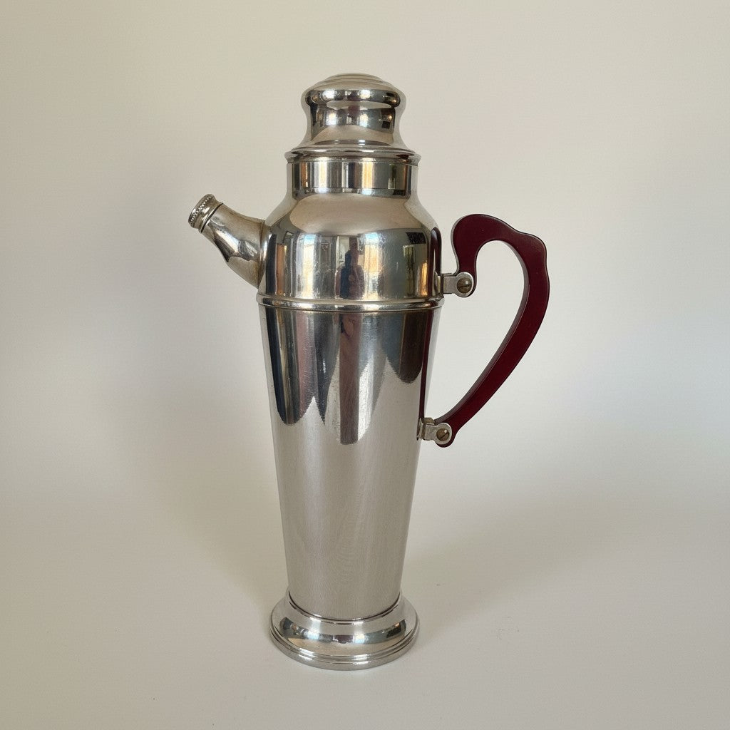 Atlas & Arden 1930s Art Deco chrome cocktail shaker with cherry red Bakelite handle and stepped base.