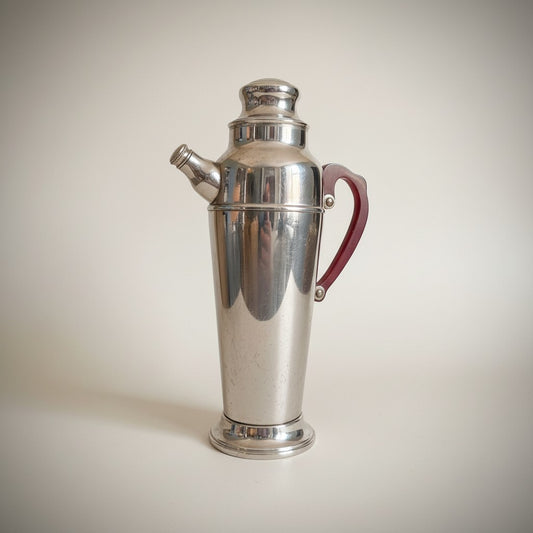 Atlas & Arden Art Deco chrome cocktail shaker with cherry red Bakelite handle, 1930s skyscraper design.