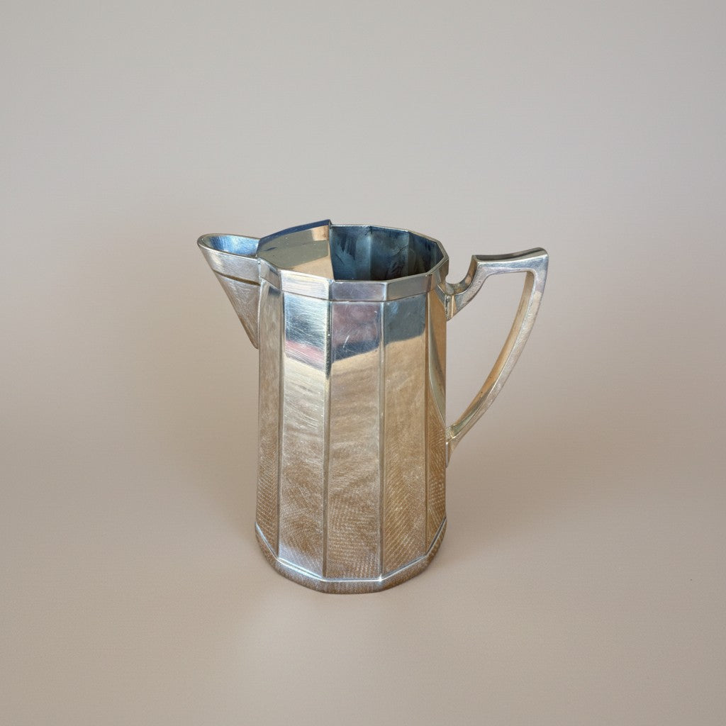 Atlas & Arden Art Deco silver plate cocktail pitcher with hinged ice guard and angular handle, 1930s.