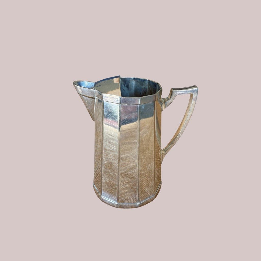 Atlas & Arden Art Deco silver plate cocktail pitcher with hinged ice guard, 1930s. Faceted design.