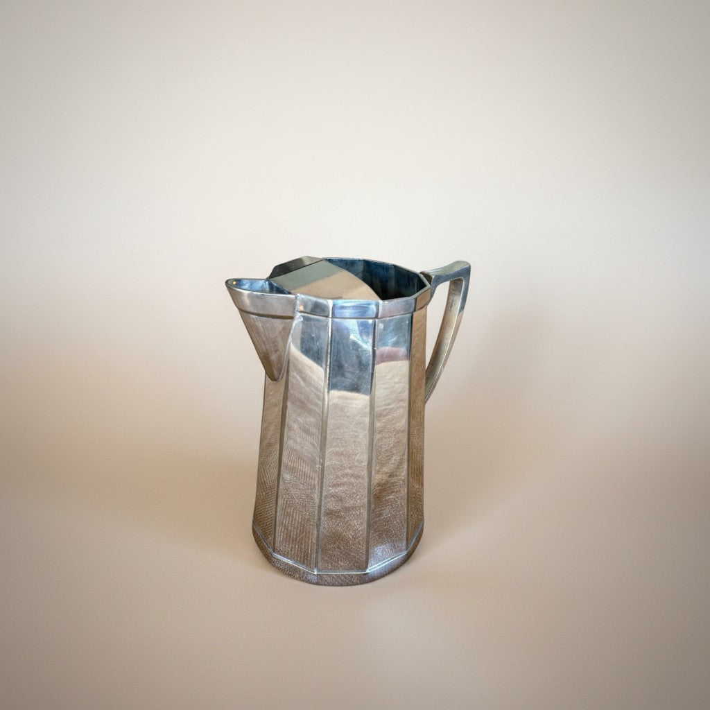 Atlas & Arden Art Deco silver plate cocktail pitcher with hinged ice guard, 1930s faceted design.
