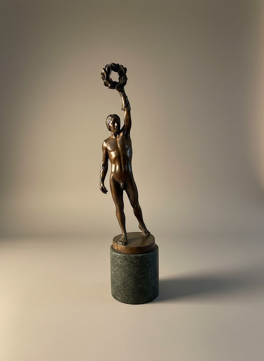 Atlas & Arden patinated bronze figure of a victorious athlete holding a laurel wreath, c. 1900-1920.
