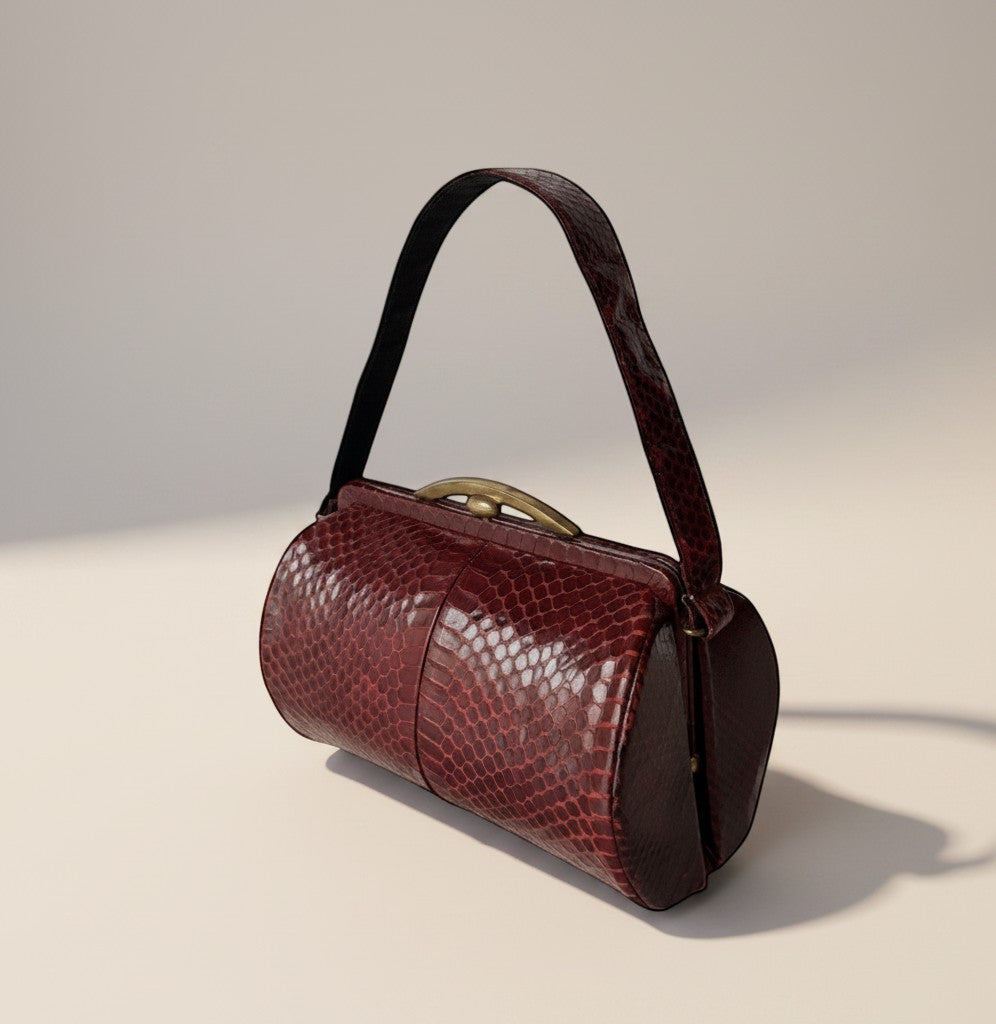 Atlas & Arden 1940s burgundy python snakeskin barrel handbag with brass kiss-lock frame and single strap.