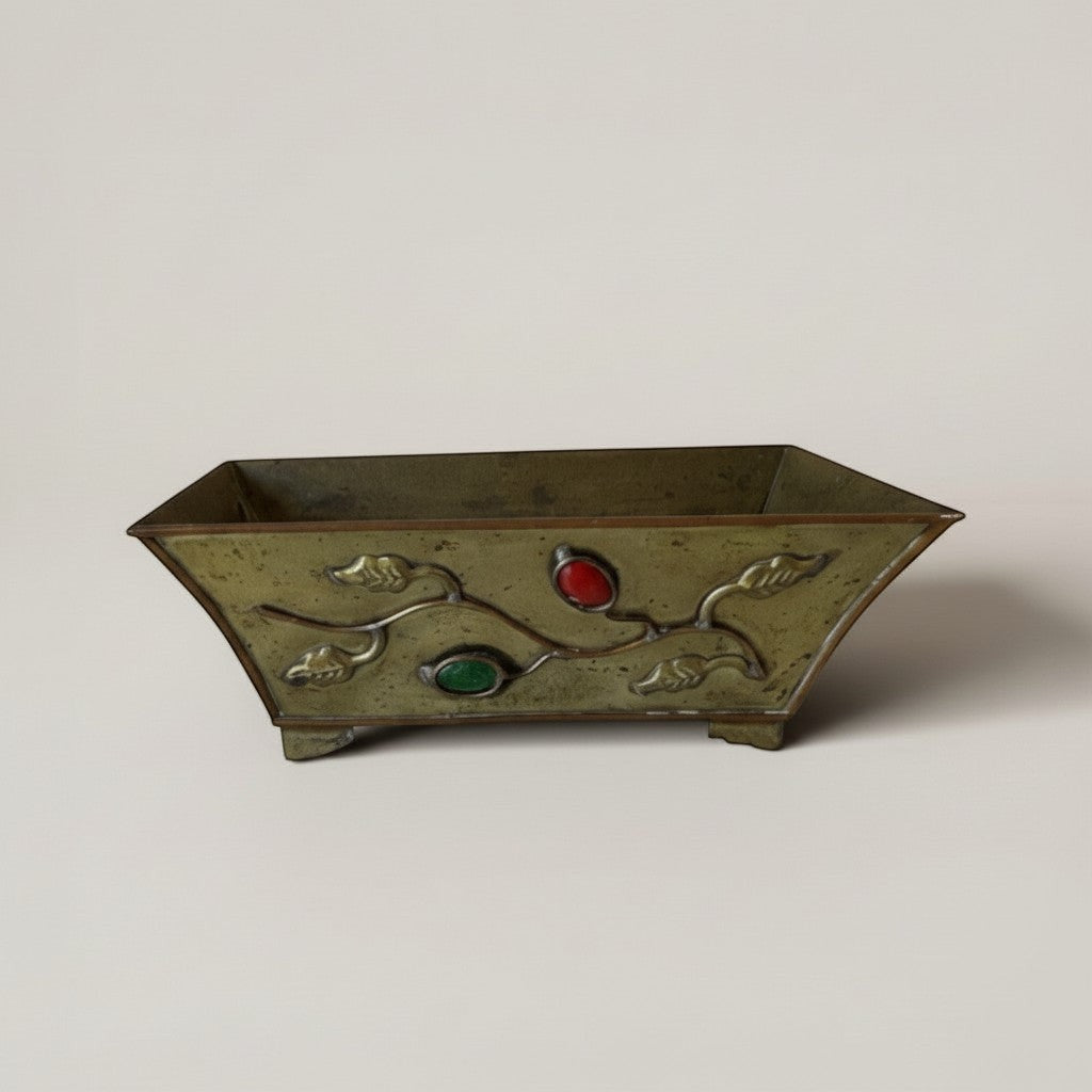 Atlas & Arden Chinese brass planter with vine motif and red/green cabochon stones, footed base, vintage patina.