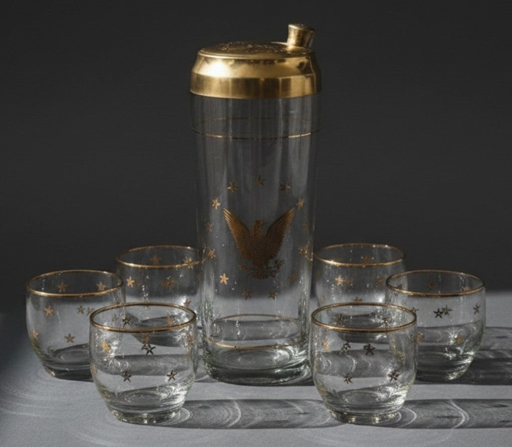 Atlas & Arden vintage Culver 22K gold Patriotic Eagle cocktail shaker set with six roly-poly glasses on grey surface.