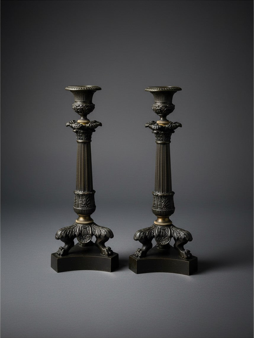 Atlas & Arden pair of antique French Charles X patinated bronze candlesticks with fluted columns and lion paw feet.