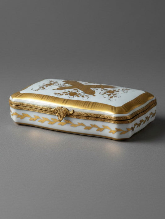 Atlas & Arden vintage Limoges porcelain box with gold gilt love trophy motifs and acanthus leaf metal clasp.