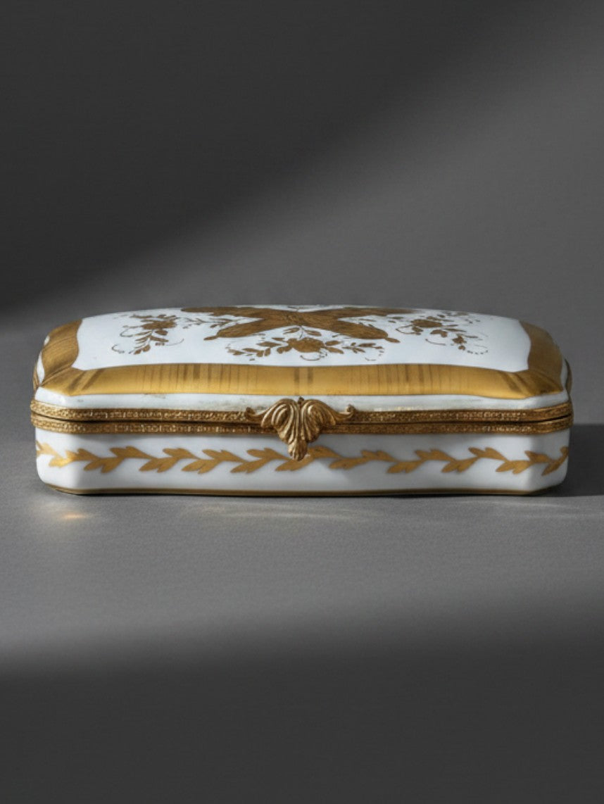 Atlas & Arden vintage Limoges porcelain box with gold gilt love trophy motifs and acanthus leaf metal clasp.