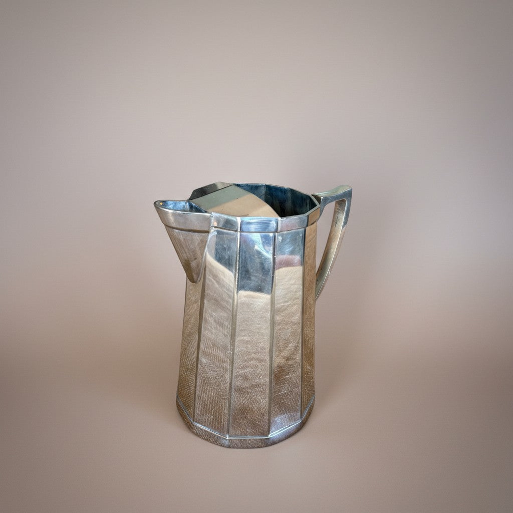 Atlas & Arden Art Deco silver plate cocktail pitcher with hinged ice guard, 1930s faceted design.