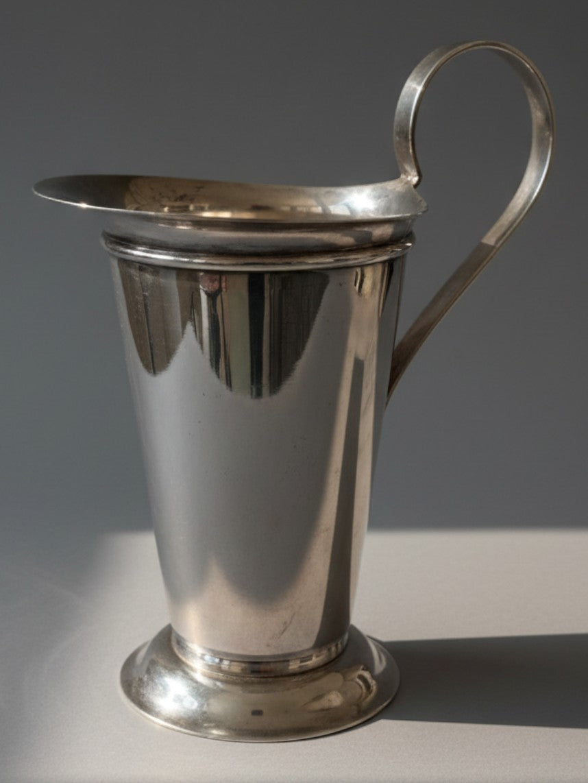 Atlas & Arden silverplate pitcher by Robert A.M. Stern for Swid Powell, featuring a Doric column design and scroll handle