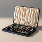 Atlas & Arden cased sterling silver tea set with eight teaspoons and a tea strainer spoon in a blue presentation case.