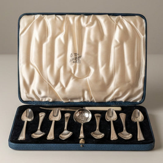 Atlas & Arden sterling silver tea set with 10 teaspoons and a tea strainer spoon in a blue presentation case. Hallmarked British silver with Old English pattern.