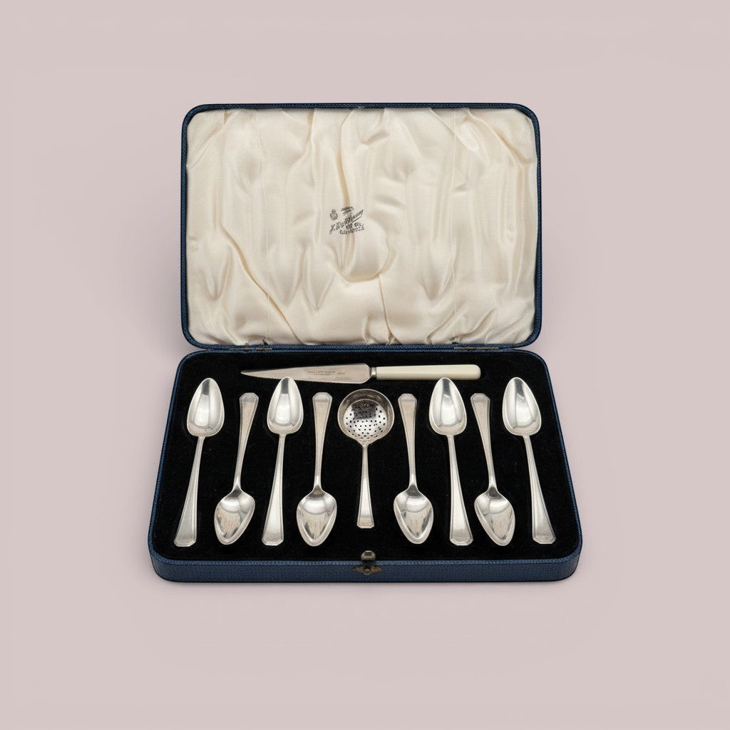 Atlas & Arden sterling silver tea set with eight teaspoons and a tea strainer spoon in a blue presentation case.