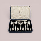 Atlas & Arden sterling silver tea set with eight teaspoons and a tea strainer spoon in a blue presentation case.