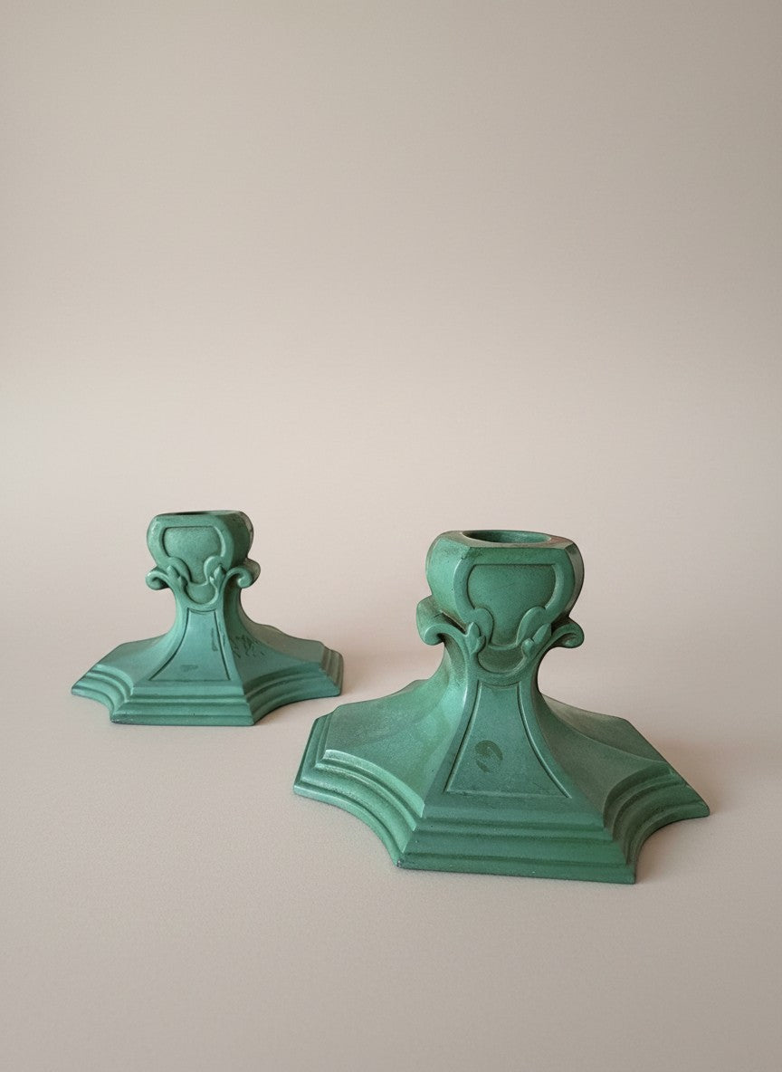 Atlas & Arden pair of verdigris matte glaze ceramic Art Deco candleholders, 1920s-30s, with stepped bases and scrolling fleur-de-lis.