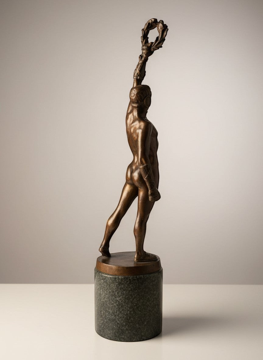 Atlas & Arden Patinated Bronze Figure of a Victorious Athlete by Robert Bauke, holding a laurel wreath aloft.