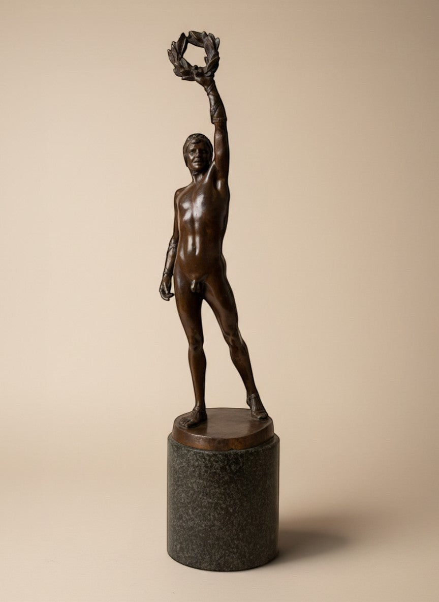 Atlas & Arden Patinated Bronze Figure of a Victorious Athlete by Robert Bauke, holding a laurel wreath aloft.