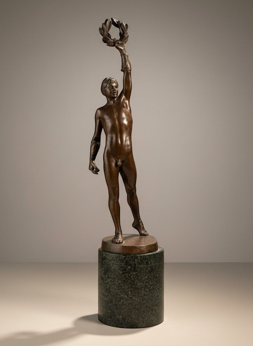 Atlas & Arden Patinated bronze figure of a victorious athlete holding a laurel wreath aloft, on a marble base.