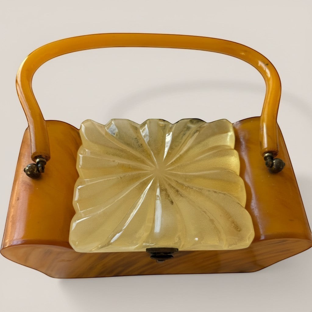 Atlas & Arden vintage 1950s butterscotch marbled Bakelite box purse with carved frosted Lucite starburst lid and rigid handle.