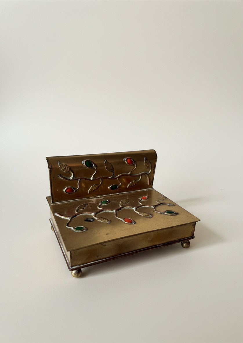 Atlas & Arden vintage brass desktop box with ornate vine design, red and green semi-precious stones, and ball feet.