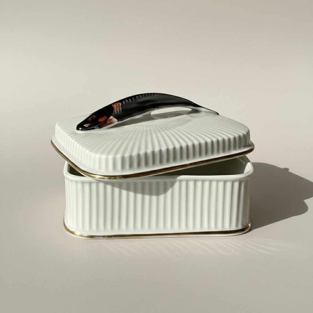 Atlas & Arden mid-century white ribbed porcelain sardine box with gold trim and a fish-shaped handle.