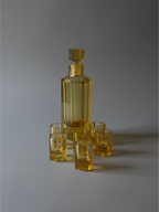 Amber crystal decanter and cordial set showing the warm honey-colored crystal.