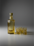 Amber crystal decanter with six matching cordials, mid-twentieth century bar set.